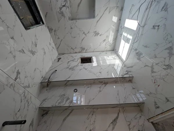 Marble-effect wet room — Tanked walls, level-access tray