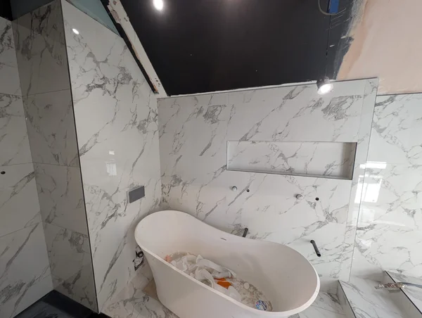 Marble-effect bathroom — Walls and floor in one matched run